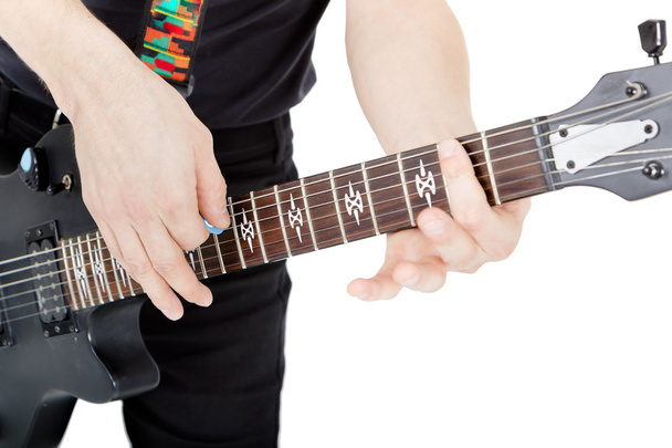 Man on a white background. Performer with an electric guitar - Foto, afbeelding