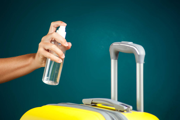 Disinfection of luggage. Travel and coronavirus concept. Studio shot - Photo, Image