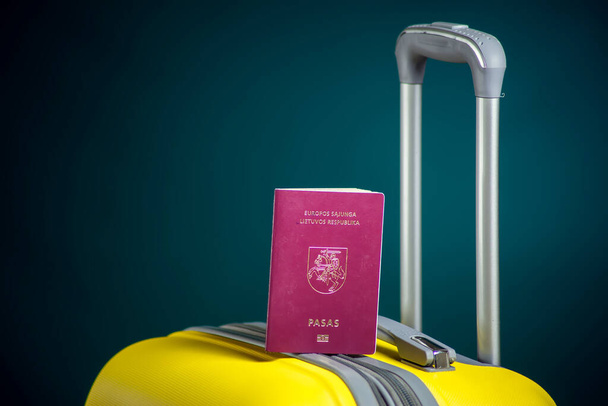 Lithuanian passport on luggage. Travel and holiday concept. Studio shot - Foto, Imagem