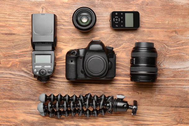 Modern photographer's equipment on wooden background - Foto, imagen