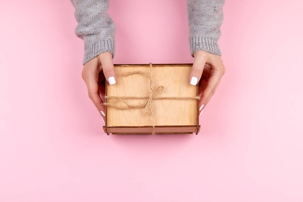 Woman hands holding wooden box - Foto, imagen