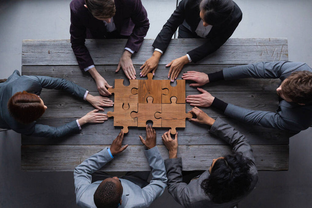Business teamwork with puzzle finishing project cooperation unity concept - Φωτογραφία, εικόνα