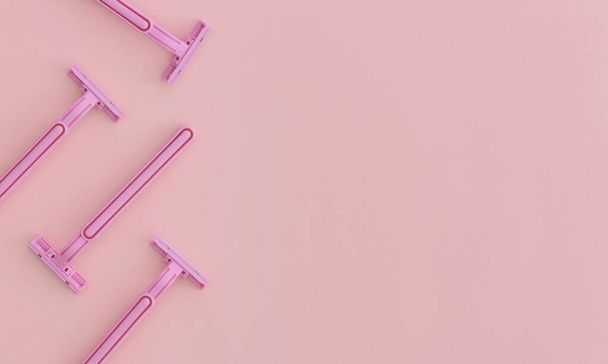 Woman pink plastic razors on pink background. Top view with copy space. Flat lay composition. - Foto, afbeelding
