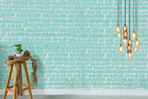 современный дизайн светильника и интерьера висит на каменной стене - Фото, изображение