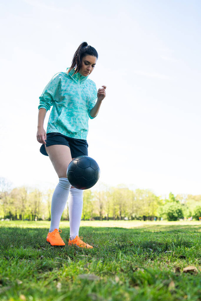 Young woman practicing soccer skills with ball. - Valokuva, kuva