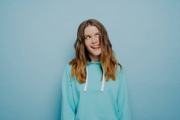 Young crazy pretty girl in light blue hoodie - Photo, Image