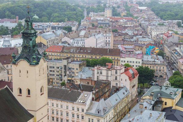 Lvov, Ukraine - 06/14/2021: Lvov panorama landmark, top view. Historical center of Lviv. Church and ancient buildings in Lvov, view from above. Old square called Rynok. Summer travel in Ukraine.  - Fotografie, Obrázek