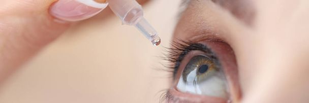 Woman drips eye drops into her eyes - Photo, Image