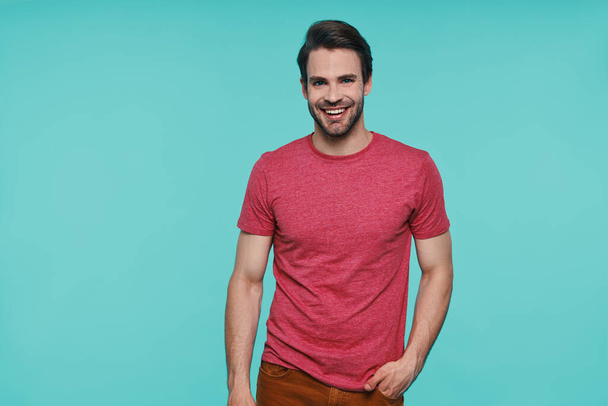 Handsome young man in casual clothing looking at camera and smiling - Photo, image