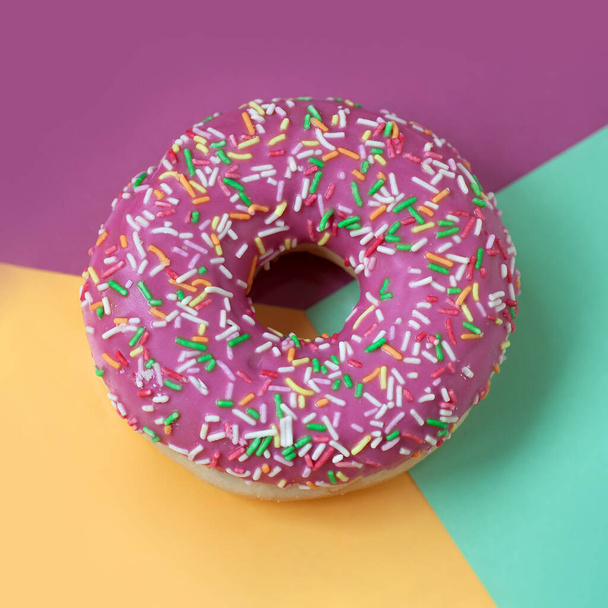 Pink Sweet donut with icing on coloful background close-up, top view. - Foto, Imagem