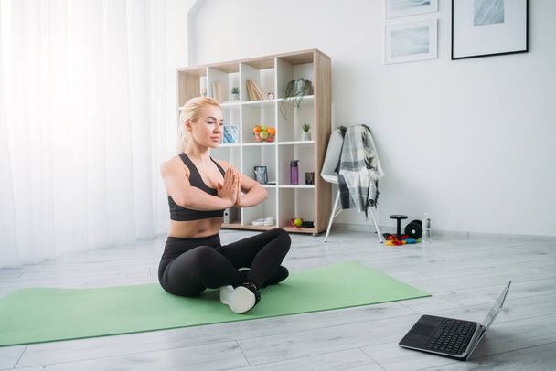 online yoga meditating woman home practice - Fotografie, Obrázek