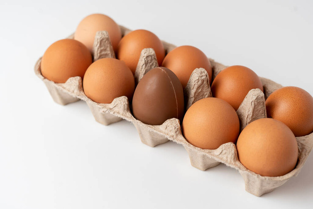 néhány nyers csirke tojás a tálcán az ch, kreatív minimális konceptocolate tojás s - Fotó, kép