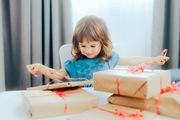 Adorable Little Toddler Girl Opening Presents for her Birthday - Фото, изображение