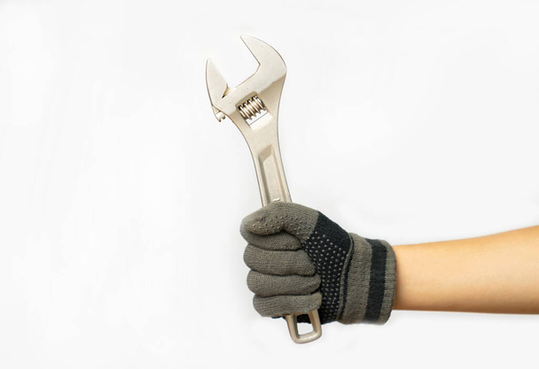 Mão de trabalho com chave ajustável contra no fundo branco isolado. - Foto, Imagem