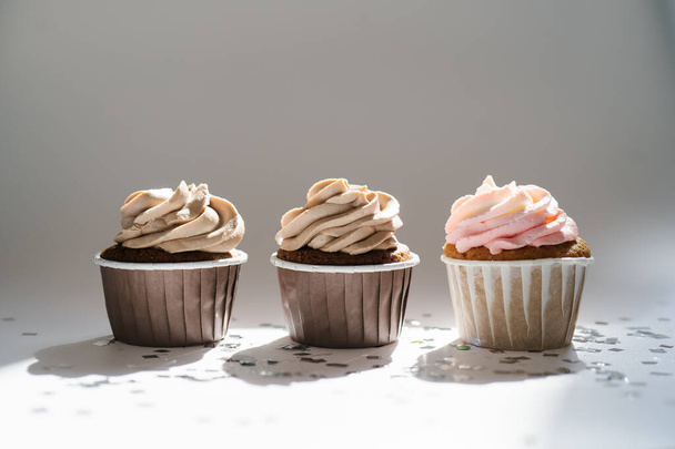 Cupcakes on a white sunny background with a shadow. - 写真・画像