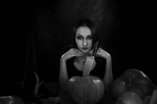 Gothic girl with pumpkins and other halloween stuff - Photo, Image