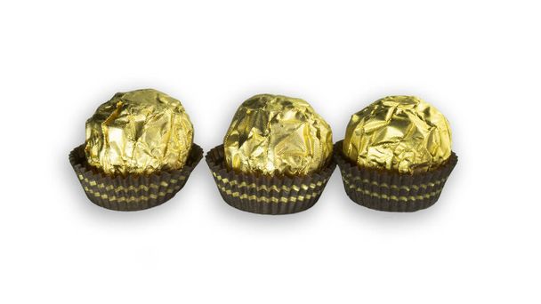 Trzy kulki czekoladowe z migdałami w złotym papierze foliowym z białym tłem - Zdjęcie, obraz