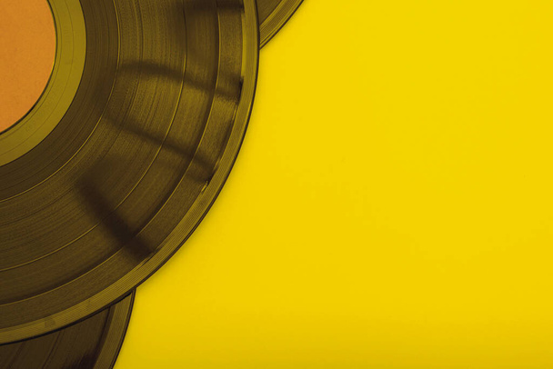 old vinyl records on a yellow background close-up. High quality photo - Photo, Image