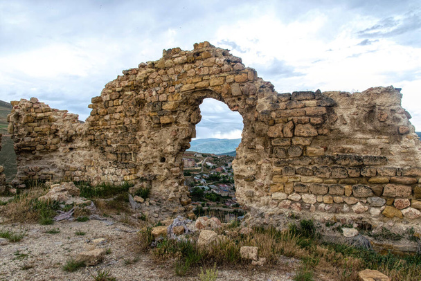 Misterious ancient ruined fortress Bayburt in Turkey, broken walls against a stormy sky - 写真・画像