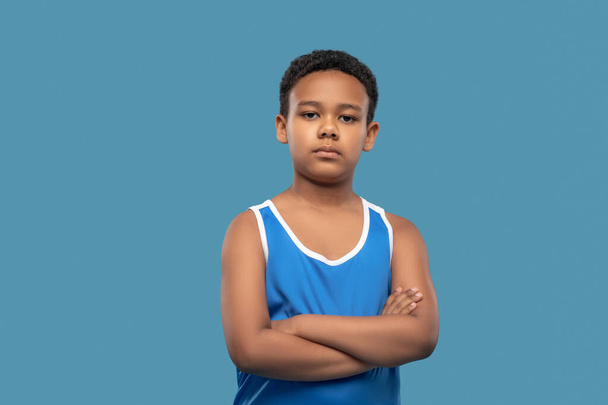 Serious boy in sports blue shirt - Photo, Image