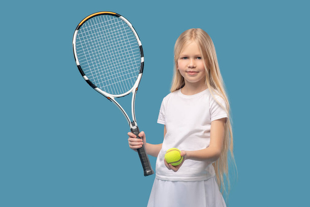 Amistosa chica rubia que ofrece jugar al tenis - Foto, imagen
