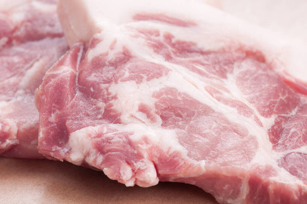 A closeup shot of raw urban digs pork neck chops ready for steak - Фото, изображение
