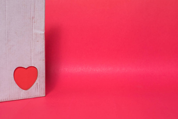A closeup shot of a handmade card with heart-shape sticker on red background - Foto, imagen