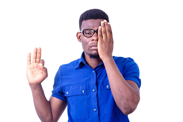 young man wearing sunglasses, covering eye with hand while making correct gesture with other hand. - Photo, Image