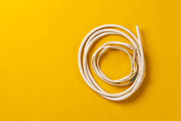 a simple white wire cord flat lay on the colorful background isolated, network connection industry - Foto, Imagen