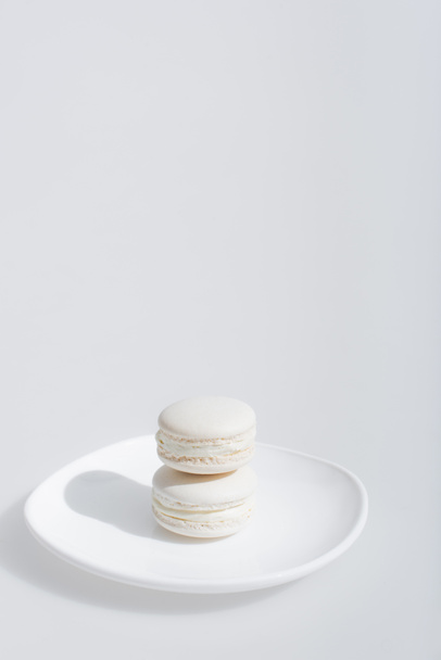 tasty and sweet macarons on plate isolated in white  - Photo, Image