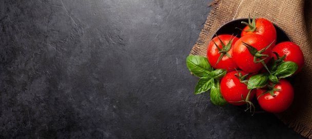 Fresh garden tomatoes and basil leaves. Top view flat lay with copy space - Fotoğraf, Görsel