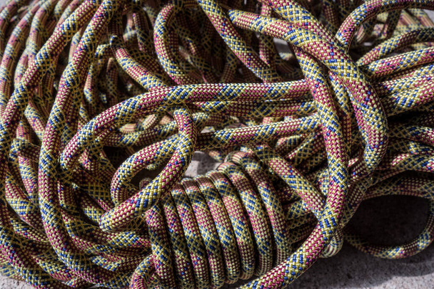 Multi-colored rock climbing ropes in bundles. Macro detail of a nylon rope. Background of the coiled sport climbing rope. - Photo, Image