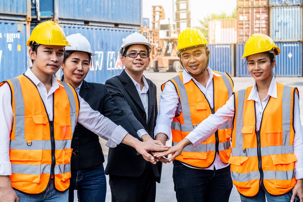 Group of employees and management team wearing logistic uniforms for exporting products abroad, stand to put your hands up and raise your hands together for a harmonious work experience - Photo, Image
