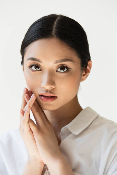 Portrait of japanese woman in white shirt isolated on grey - Photo, Image