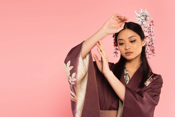Pretty japanese woman in traditional wear isolated on pink  - 写真・画像