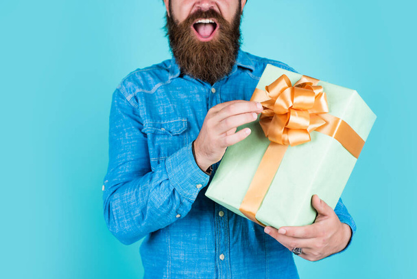 surprise for him. shopping and sale. mature brutal hipster with present. buy in mall. happy bearded man holding gift box. happy birthday or anniversary. holiday celebration - 写真・画像