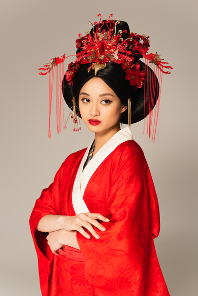 Pretty asian woman with red lips and traditional clothes isolated on grey  - Photo, Image