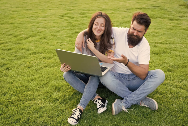 Cheerful couple watching series laptop outdoors, have fun concept - Фото, зображення