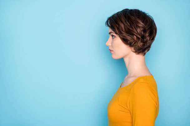 Profile portrait of nice serious brunette lady look empty space wear yellow shirt isolated in vivid blue color background - Fotografie, Obrázek