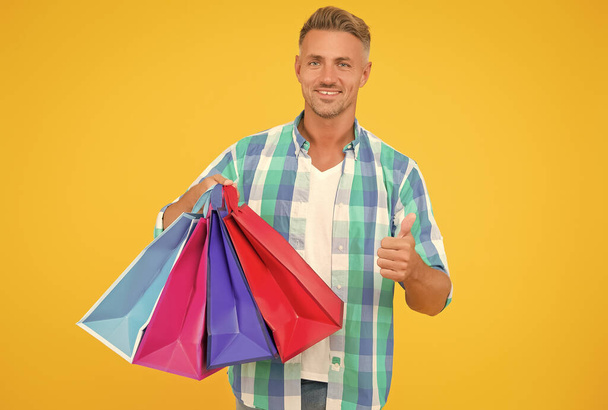 happy handsome man holding packages with purchase preparing for holiday, gift shopping - Фото, зображення