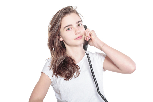 smiling teenager girl talking on the phone, isolated on white - 写真・画像
