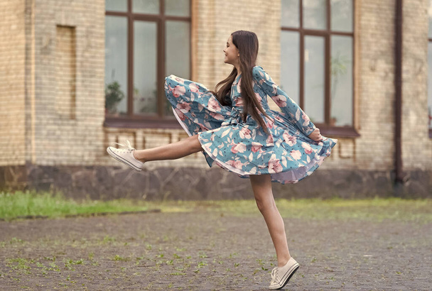 Girl summer dress flutters in motion urban background, against wind concept - Foto, imagen
