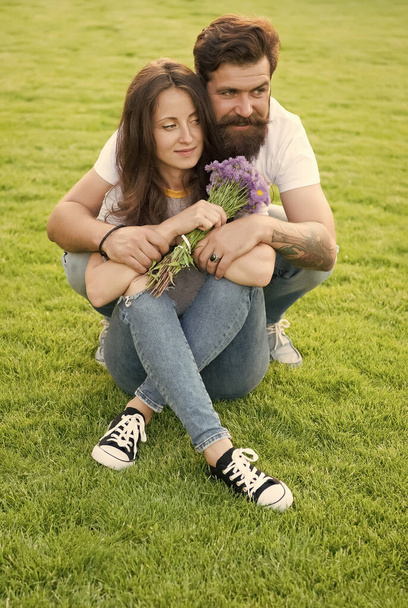 Lovely couple cuddling relaxing on green meadow, always together concept - Fotografie, Obrázek