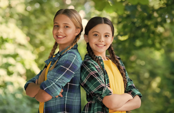 Happy cute girls friends smile in casual fashion style keeping arms crossed summer landscape, friendship - Fotografie, Obrázek