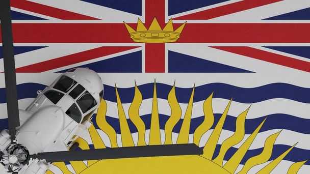 Bovenaanzicht van een witte helikopter in de linkerbenedenhoek en bovenop de vlag van Brits Columbia - Foto, afbeelding