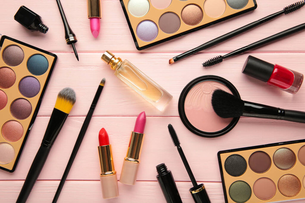 Different luxury makeup products on pink background, flat lay. Top view - Photo, Image
