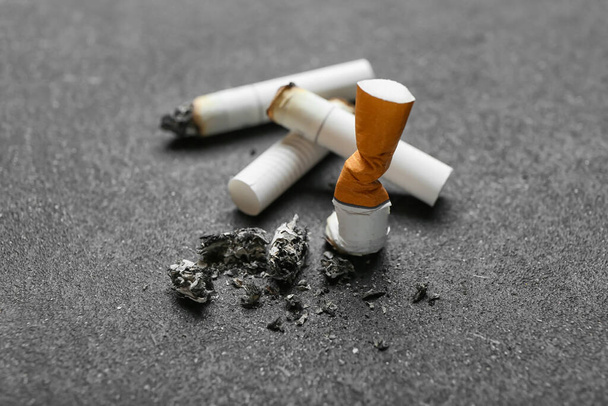 Cigarette butts on dark background - Photo, image