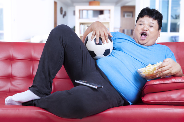 Fat man watching football match at home - Photo, Image