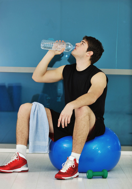 Young man in fintess sport club exercise withweights and relaxing - Fotó, kép
