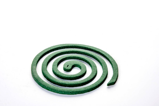A mosquito coil is a mosquito-repelling incense, usually made into a spiral, and typically made using dried paste of pyrethrum powder. The coil is usually held at the center,suspending it in the air. - Photo, Image